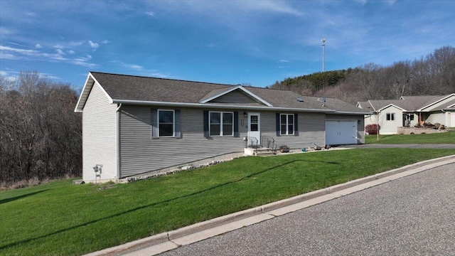 single story home with a garage and a front lawn