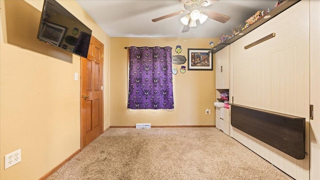 unfurnished room featuring ceiling fan and light colored carpet