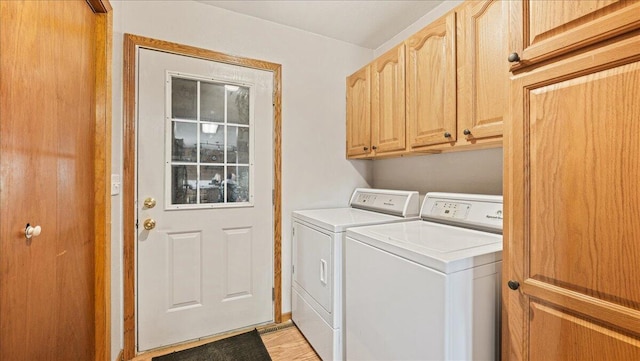 washroom featuring washer and clothes dryer and cabinets