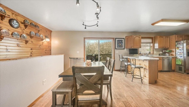 dining room with rail lighting and light wood-type flooring