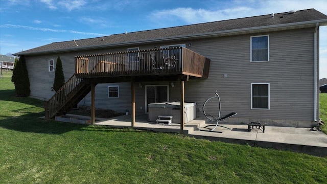 rear view of house with a patio area, a deck, a yard, and a hot tub