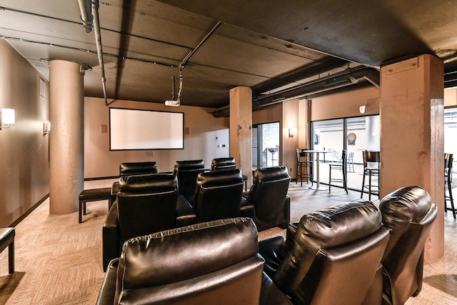 carpeted home theater with ornate columns