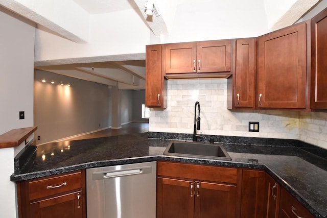 kitchen featuring dishwasher, decorative backsplash, dark stone countertops, and sink