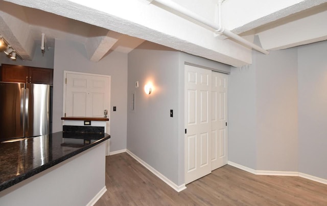 hallway with beamed ceiling and light wood-type flooring