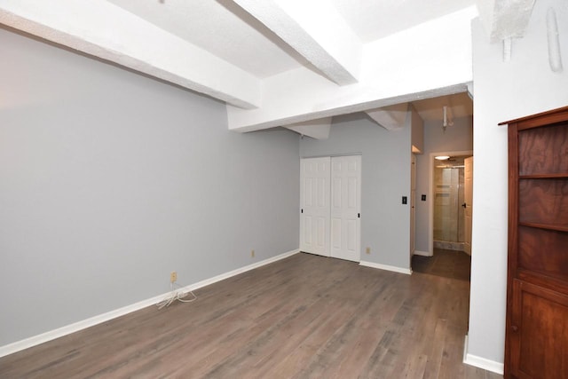 basement with dark hardwood / wood-style floors