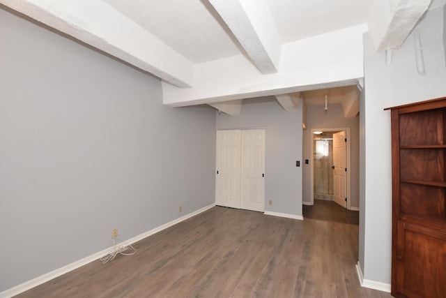 basement featuring a textured ceiling and dark wood-type flooring