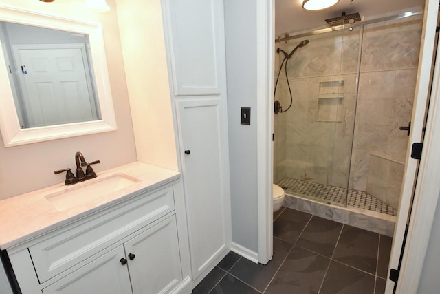 bathroom with tile patterned flooring, vanity, toilet, and walk in shower