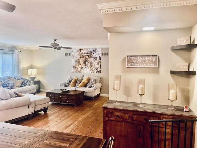 living room featuring ceiling fan, light hardwood / wood-style floors, and ornamental molding