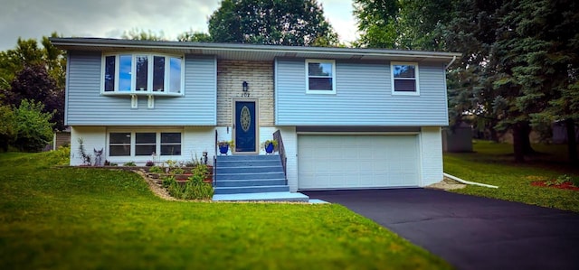 raised ranch with a garage and a front lawn