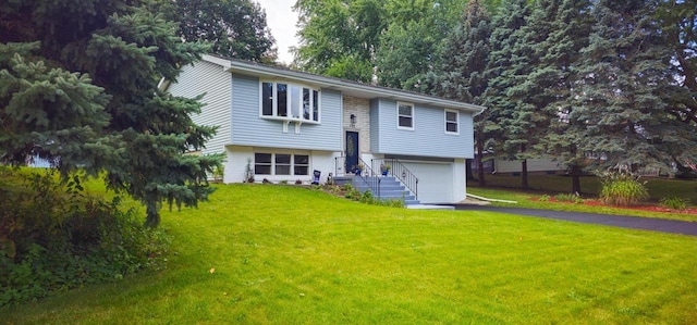 split foyer home featuring a garage and a front lawn