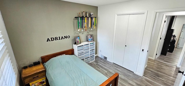 bedroom with hardwood / wood-style flooring and a closet