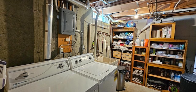 clothes washing area featuring sink, electric panel, and washing machine and clothes dryer