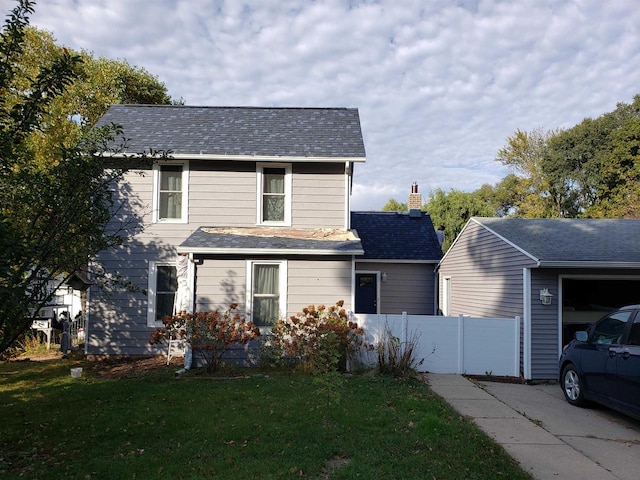 front facade with a front yard and a garage