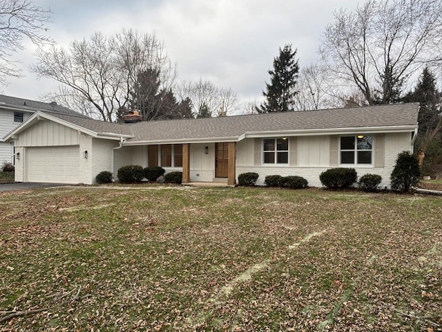 ranch-style house with a garage and a front lawn