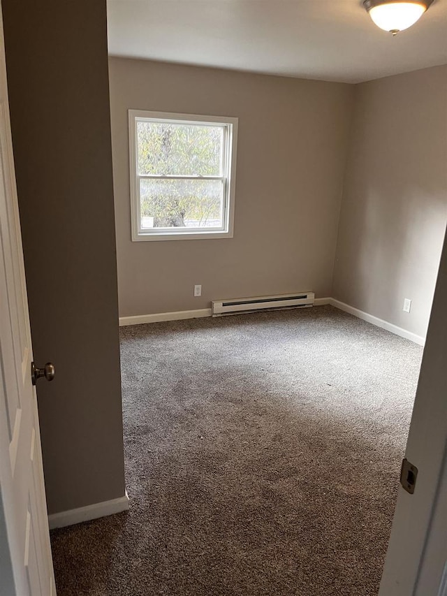 unfurnished room featuring dark colored carpet and a baseboard radiator