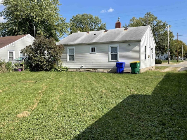 rear view of property with a yard