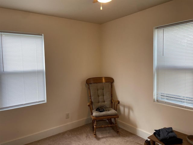 sitting room with plenty of natural light and light carpet