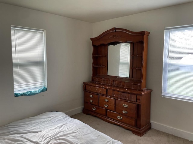 bedroom featuring light colored carpet