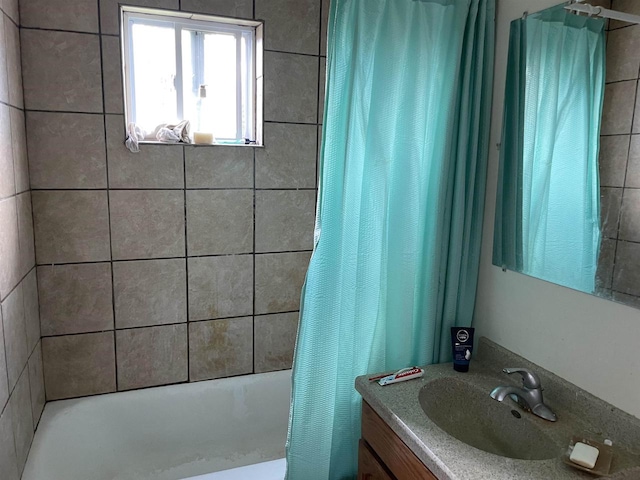 bathroom with shower / bath combination with curtain and vanity