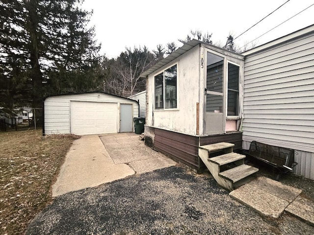 view of property exterior featuring a garage and an outdoor structure