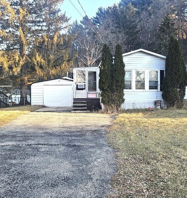 manufactured / mobile home with an outbuilding and a garage