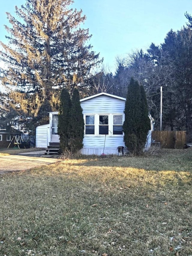 view of side of property featuring a yard