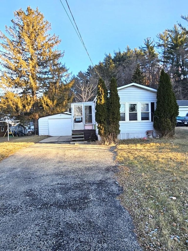 view of front of home with a garage and an outdoor structure