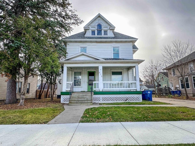 view of front of home featuring a porch and a front lawn