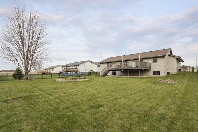 view of yard featuring a deck and a trampoline