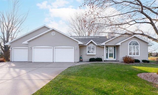 ranch-style home featuring a garage and a front lawn