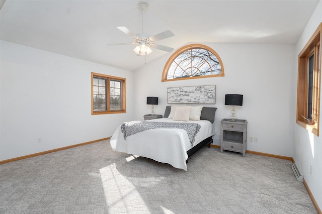 bedroom with ceiling fan, light colored carpet, and vaulted ceiling