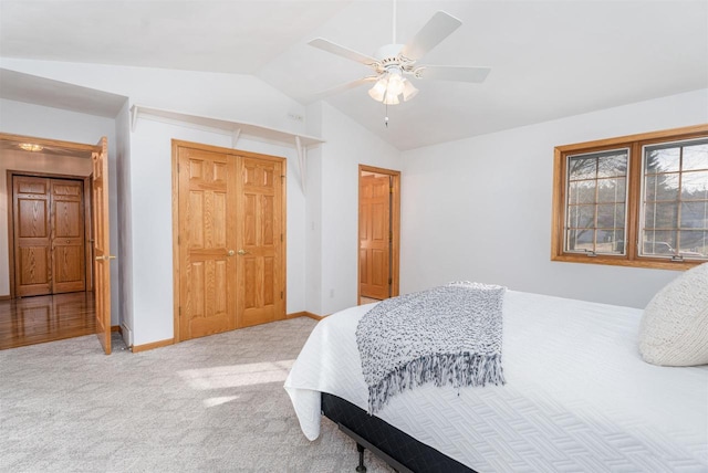 carpeted bedroom featuring vaulted ceiling, a closet, and ceiling fan