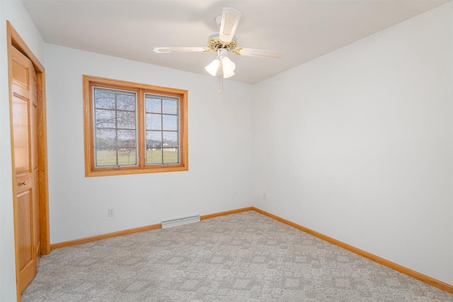 empty room featuring light colored carpet and ceiling fan