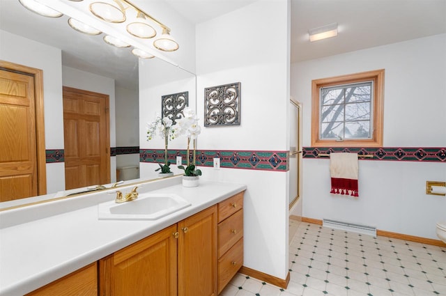 full bathroom with enclosed tub / shower combo, vanity, and toilet