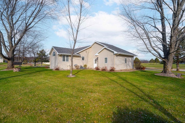 view of side of property featuring a yard