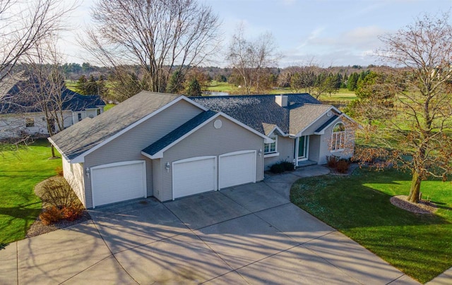 ranch-style house featuring a garage and a front lawn