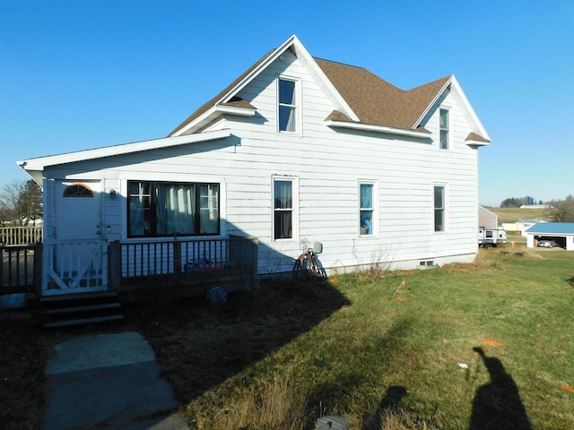 rear view of house with a yard