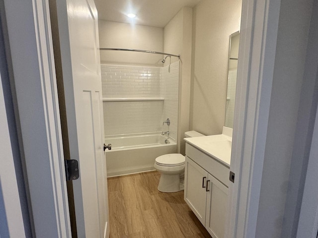 full bathroom featuring vanity, wood-type flooring, shower / bathtub combination, and toilet