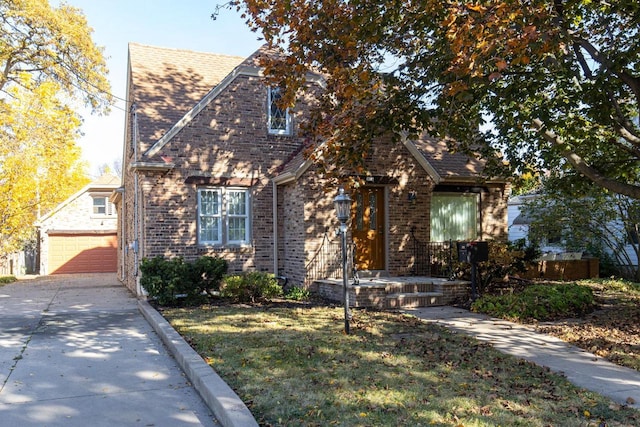 view of front of property with an outbuilding, a garage, and a front lawn