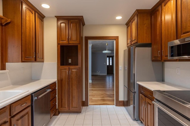 kitchen with sink, light hardwood / wood-style flooring, and appliances with stainless steel finishes