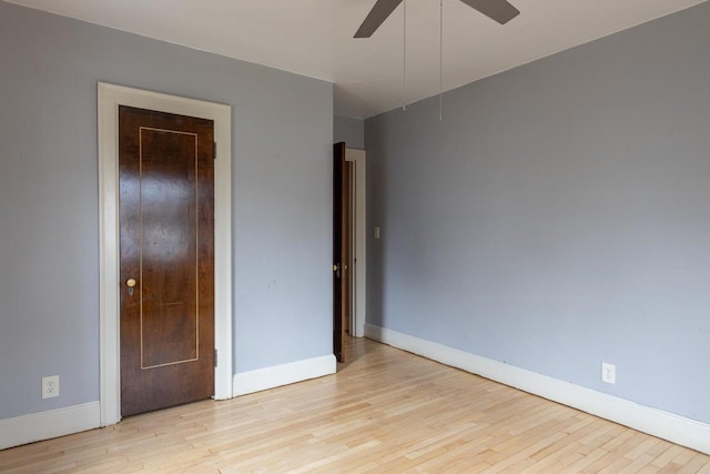 unfurnished bedroom with ceiling fan and light wood-type flooring