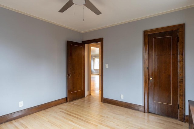 unfurnished room with ceiling fan, light hardwood / wood-style flooring, crown molding, and a baseboard heating unit