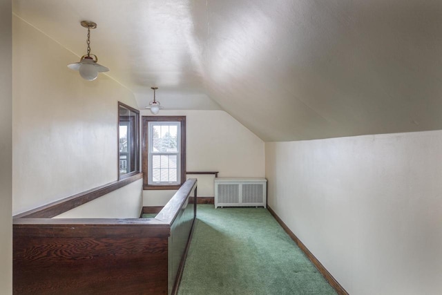 additional living space featuring lofted ceiling, radiator heating unit, and carpet floors