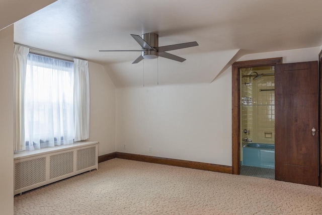 additional living space featuring carpet flooring, radiator heating unit, vaulted ceiling, and ceiling fan