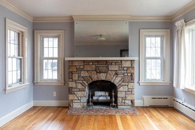 room details with hardwood / wood-style flooring, a baseboard radiator, a stone fireplace, and crown molding