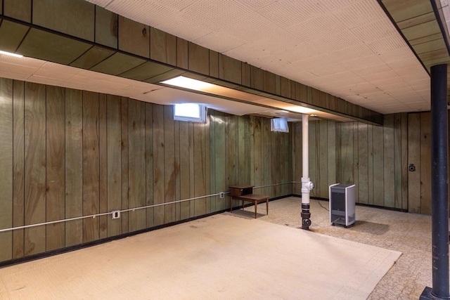 basement with carpet flooring and wooden walls