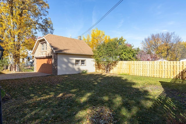 view of property exterior featuring a yard and a garage