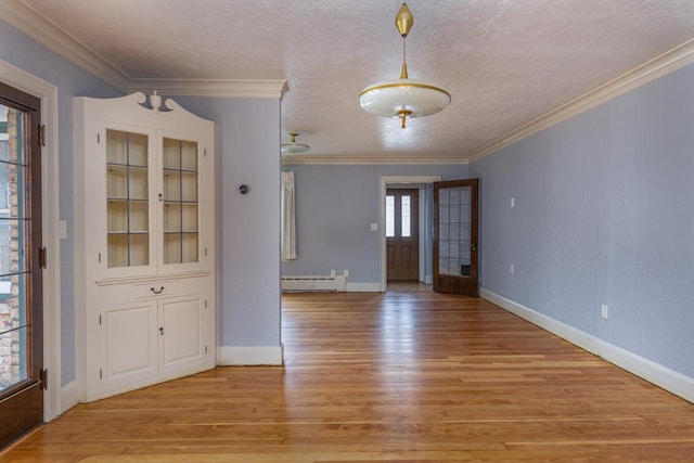 interior space featuring french doors, light hardwood / wood-style flooring, ornamental molding, a textured ceiling, and baseboard heating