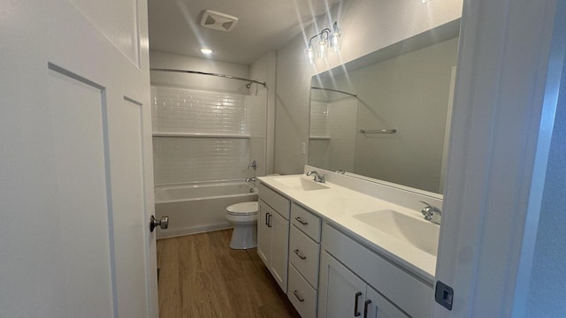 full bathroom with bathtub / shower combination, hardwood / wood-style floors, vanity, and toilet