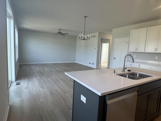 kitchen featuring sink, decorative light fixtures, light hardwood / wood-style flooring, dishwasher, and white cabinets